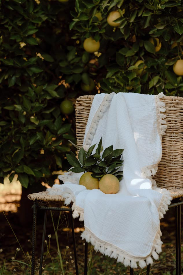 Wanderlust collection: Muslin swaddle with natural fringe detail.